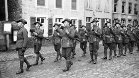 Soldiers marching through streets in WWI